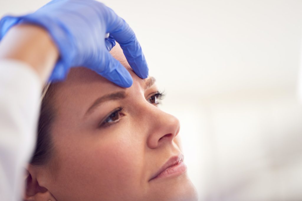 Beautician Or Doctor Preparing Female Patient For Botox Injection